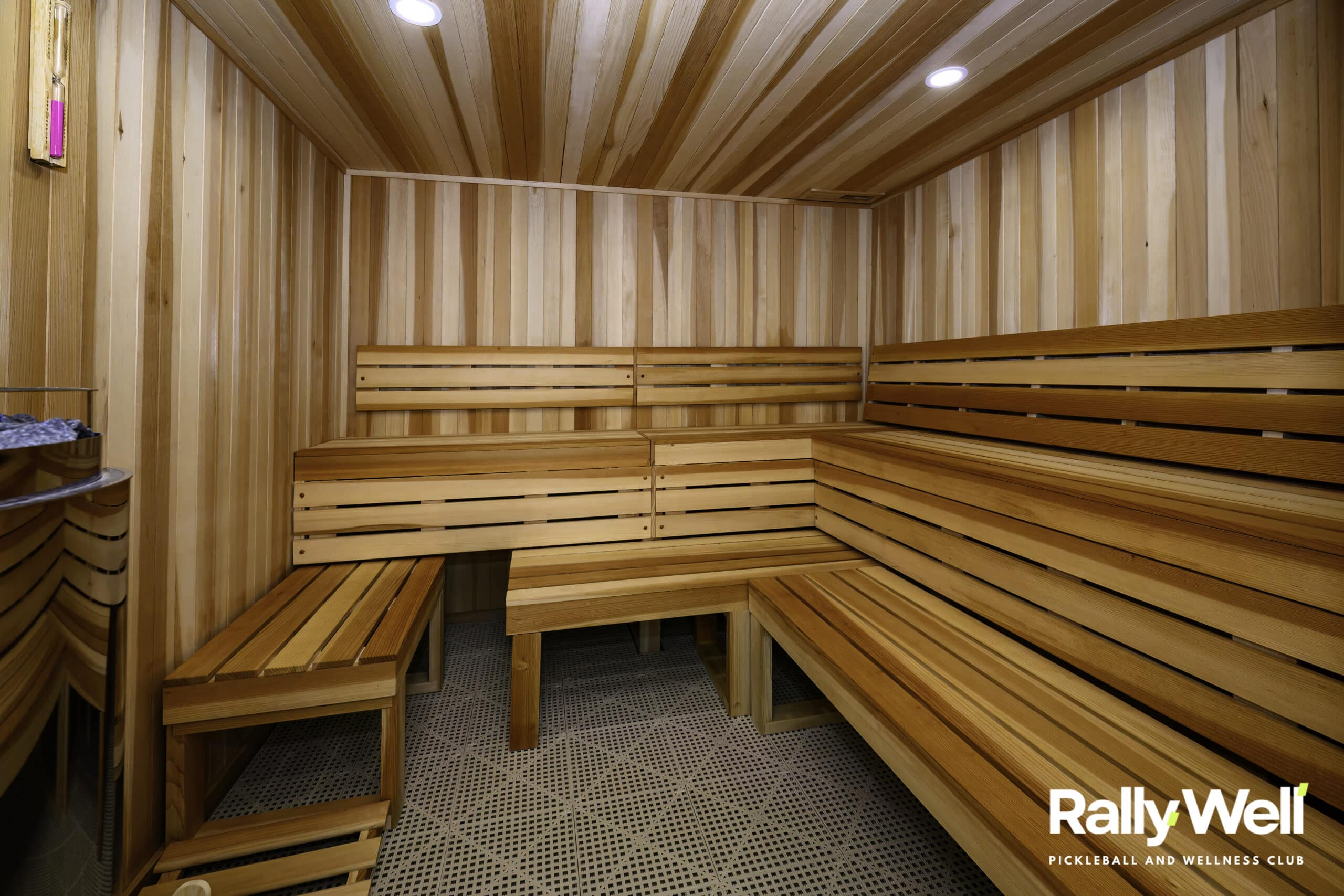 Cedar sauna room with tiered benches at RallyWell Wellness Recovery Club