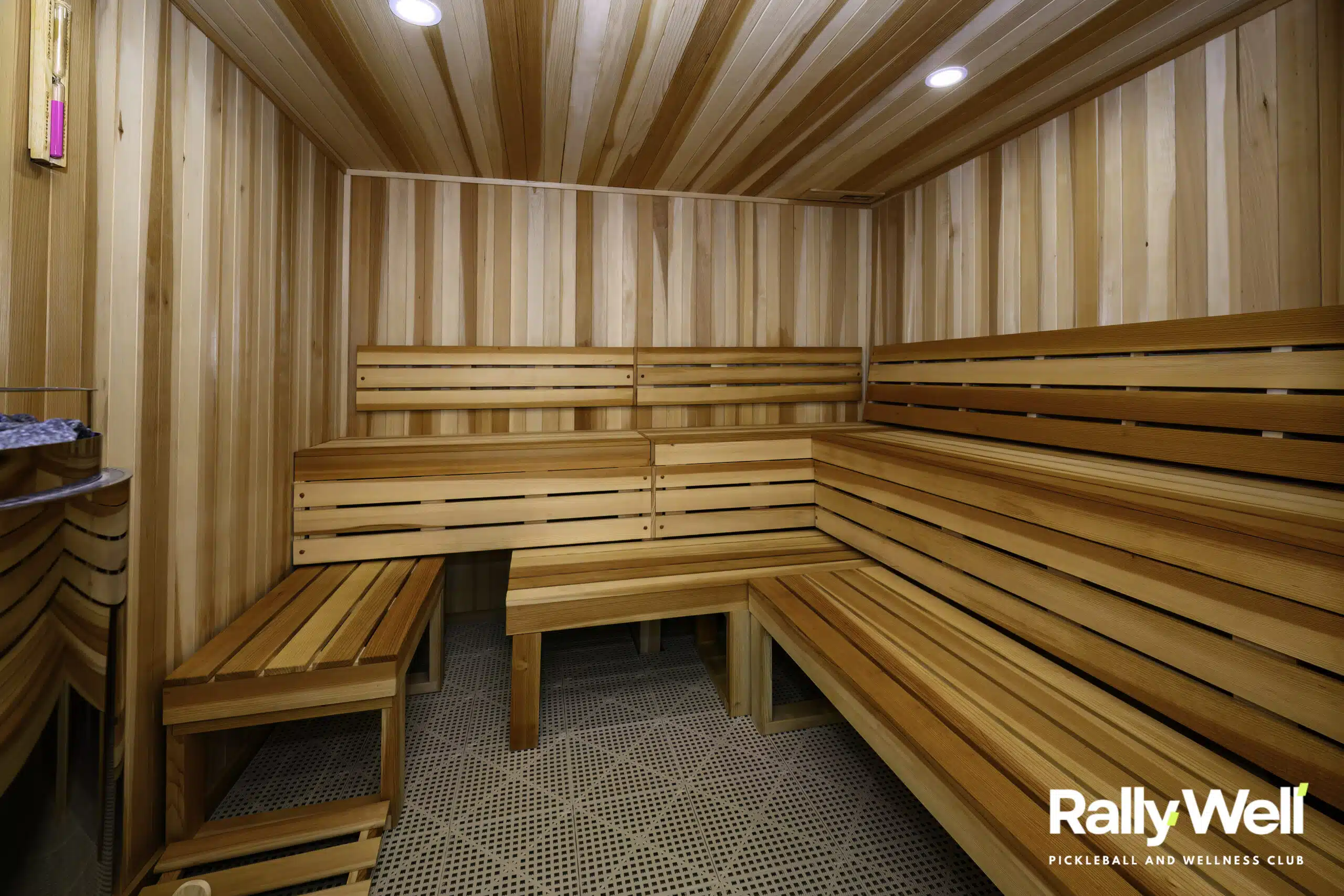 Cedar sauna room with tiered benches at RallyWell Wellness Recovery Club